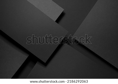 Dark graphite grey abstract textured geometric stepped background with fly rectangle paper sheets, stripe with corner, lines in hard light, black shadows in luxury business style for design, top view. Royalty-Free Stock Photo #2186292063
