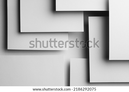 White abstract geometric background in simple elegant business modern style with flying white surfaces as relievo pattern with rectangles, parallel stripes, shadows, perspective and gradient.