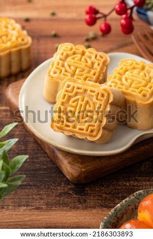Delicious mung bean moon cake for Mid-Autumn Festival food mooncake on dark wood table background for afternoon tea, holiday celebration serving.