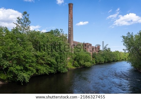 Blackstone River Valley National Historic Park. Ashton Mill brick smokestack. Former cotton mill now apartments for Providence area. Village remains example of a Rhode Island System mill village. Royalty-Free Stock Photo #2186327455