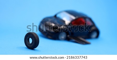 a crashed car with wheel on a blue background


