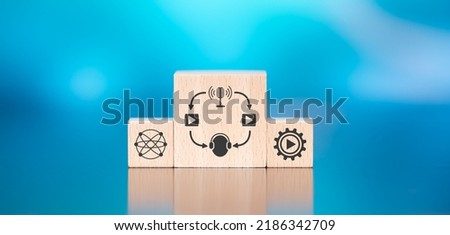 Wooden blocks with symbol of podcast concept on blue background