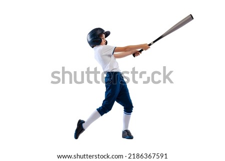 Hitting. Sportive kid, beginner baseball player in sports uniform with bat isolated on white background. Concept of sport, achievements, competition. School age boy learning to play baseball