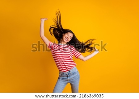 Portrait of overjoyed charming black hair girl chilling dancing wear white red t-shirt isolated on yellow color background
