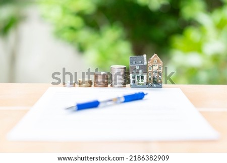 Insurance real estate  form agreement, buy and sell home model on out of focus background. Insurance, finance, saving concept.