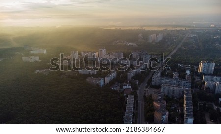 Sunny morning cityscape in city residential district. Aerial colorful view above buildings and streets in sun light, Pavlovo Pole, Kharkiv Ukraine Royalty-Free Stock Photo #2186384667