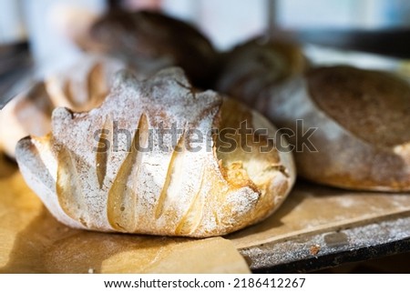 Artisan bread on the counter in the bakery. The process of making bread. Vertical photo.