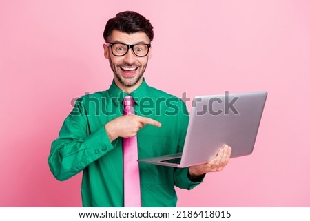 Photo of funky excited man dressed green shirt eyewear pointing finger modern gadget isolated pink color background