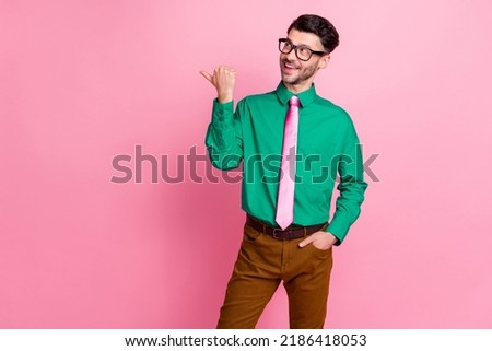 Photo of elegant man indicate hand own barbershop propose visit enjoy haircut atmosphere empty space isolated on pink color background