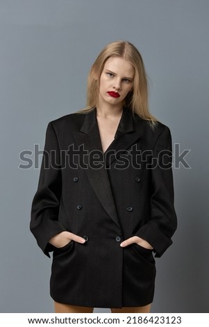portrait of a woman stylish black blazer red lips isolated background