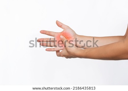 Cropped shot of a young woman holding a palm in her hand isolated on a white background. Numbness of the limbs. Injuries, arm pain, carpal tunnel syndrome, neuralgia. Medical concept