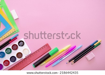 school stationery on pink background with copy space, back to school.