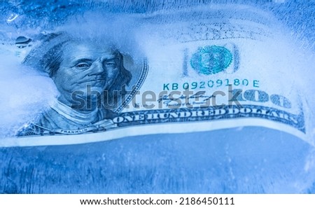 100 US dollar frozen under a layer of ice for design purpose