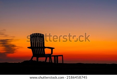 Armchair on the background of sunset. Armchair silhouette at sunset. Sunset armchair silhouette. Armchair at sunset Royalty-Free Stock Photo #2186458745
