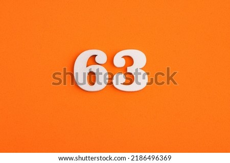 Number 63 - On orange foam rubber background