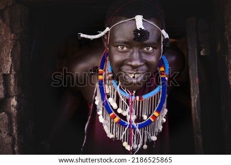 Portrait of Maasai mara man with traditional colorful necklace at Maasai Mara tribe village, Safari travel destination near Maasai Mara National Reserve, Kenya Royalty-Free Stock Photo #2186525865