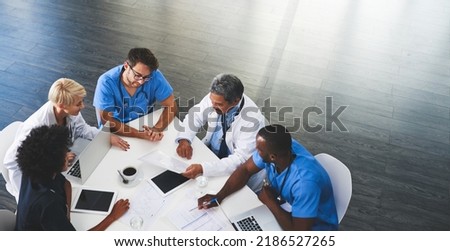 Doctor, nurse and healthcare professional team or group sitting in the boardroom, talking about medicine and discussing treatment during a meeting. Planning and brainstorming a health cure from Royalty-Free Stock Photo #2186527265