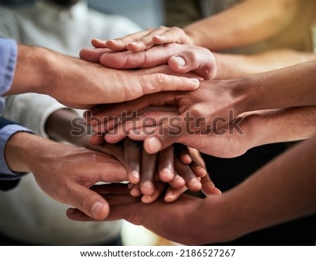 Diverse hands in unity, support and teamwork at a business or company that is winning. Group of corporate employees, colleagues and coworkers in trust, victory and motivation together Royalty-Free Stock Photo #2186527267