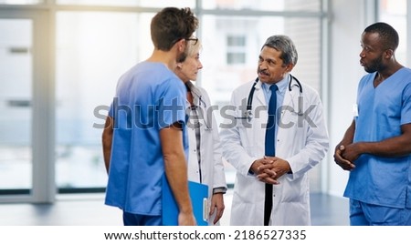 Talking doctors, medical professionals and healthcare workers planning or brainstorming hospital medicine treatment. Diverse group of frontline clinic colleagues discussing new breakthrough in virus Royalty-Free Stock Photo #2186527335