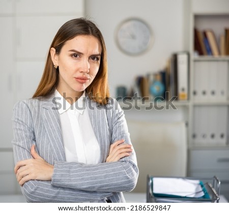 Portrait of thoughtful young caucasian woman office worker.