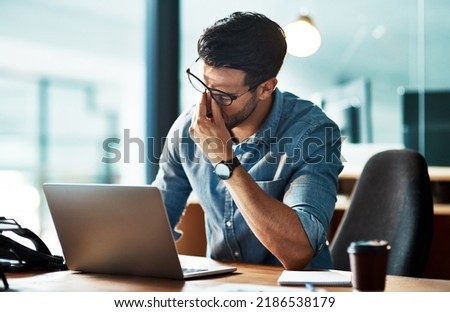 Stressed, tired and frustrated business man with headache at night from burnout or making mistake on laptop. Overworked creative entrepreneur failing to meet late office deadline or working overtime Royalty-Free Stock Photo #2186538179