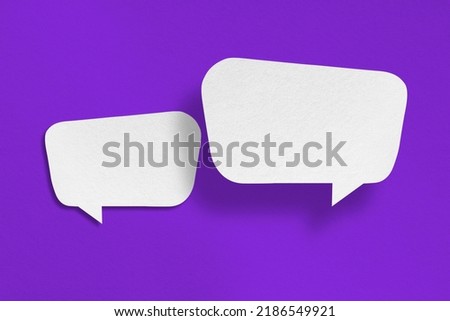 white paper with speech bubbles isolated on purple background communication bubbles design