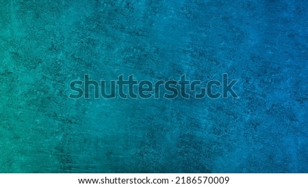 Dark blue green wall texture. Gradient. Deep teal color. Toned old rough concrete surface. Close-up. Abstract vintage background with space for design. Web banner.  Royalty-Free Stock Photo #2186570009