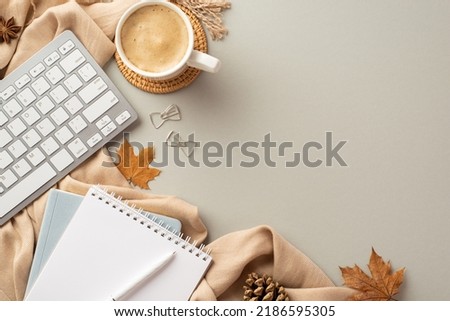 Autumn business concept. Top view photo of reminders pen bow shaped clips keyboard cup of coffee on rattan serving mat anise fallen maple leaves pine cone and plaid on isolated grey background