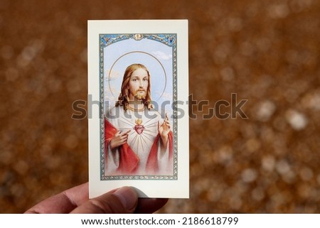 Devotion to the Sacred Heart of Jesus. Holy image in hand. 