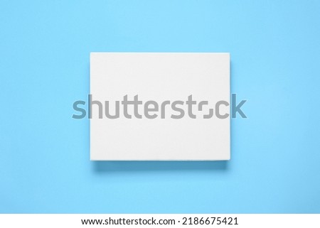Blank canvas on light blue background, top view. Space for design
