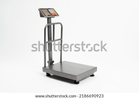 Industrial scale for weighing parcels for shipping. Grey metal scale isolated on white background. Royalty-Free Stock Photo #2186690923