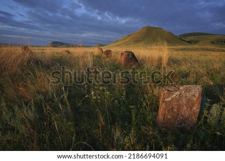 View of ancient burial mounds and menhirs in  steppes and mountains of Khakassia.