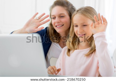 View of a Attractive woman and little sister videocalling Royalty-Free Stock Photo #218670250