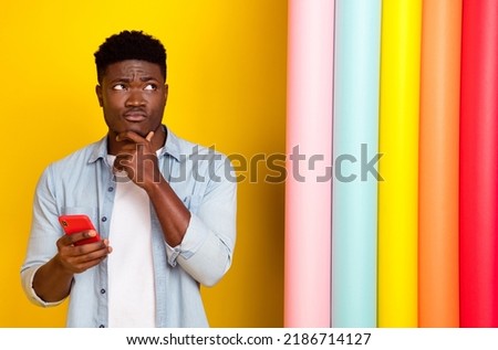 Photo of pensive guy use device hesitate order delivery painted rolls isolated shine color background Royalty-Free Stock Photo #2186714127
