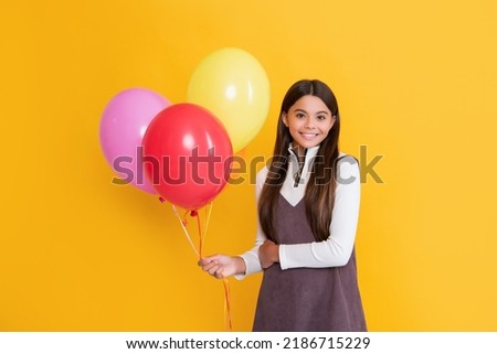 girl with party colorful balloons on yellow background