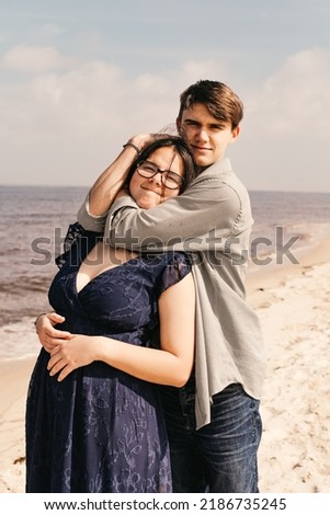 A young man playfully putting his girlfriend in a head lock.