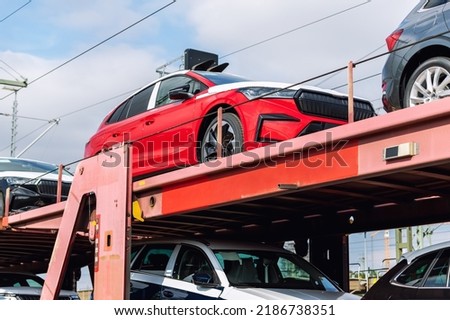 Mane new modern electric and fuel cars transportation by cargo freight train railway wagon. Railroad export and import automotive logistics service. Safety and insurance goods shipping insdustry Royalty-Free Stock Photo #2186738351