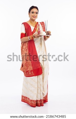 Bengali woman with puja thali. Royalty-Free Stock Photo #2186743485