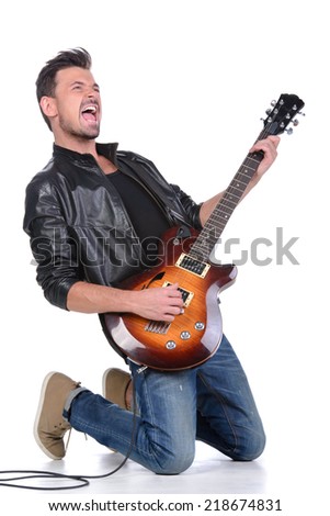 Young musician playing guitar, isolated on white