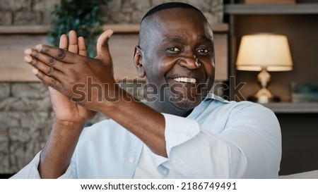 Elderly male portrait African American brunette man with wrinkles smiling congratulating applauding ethnic senior grandpa mature pensioner cheering clapping hands expresses admiration approval Royalty-Free Stock Photo #2186749491