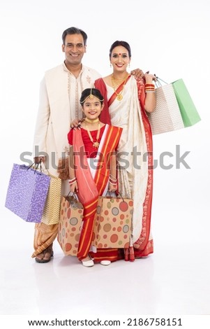 Bengali family with shopping bags over white background. Royalty-Free Stock Photo #2186758151