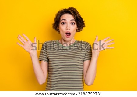 Photo of young shocked beautiful lady wear striped khaki t-shirt surpised bitcoin goes down isolated on bright yellow color Royalty-Free Stock Photo #2186759731
