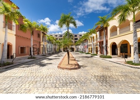 Empty streets in Cap Cana village with colorful houses, beautiful nature at sunny day. Luxury residence in Dominican Republic Royalty-Free Stock Photo #2186779101