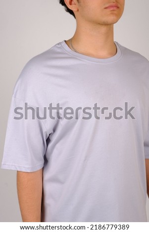 Close up pattern of cotton man in white t-shirt isolated on gray background.
