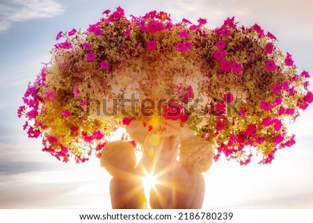 Sunrays between cherubins and violet flowers vase pot, Paris, France