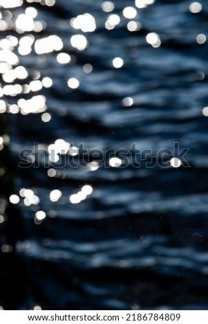 Abstraction, bokeh on a blurred background of water, glitter.