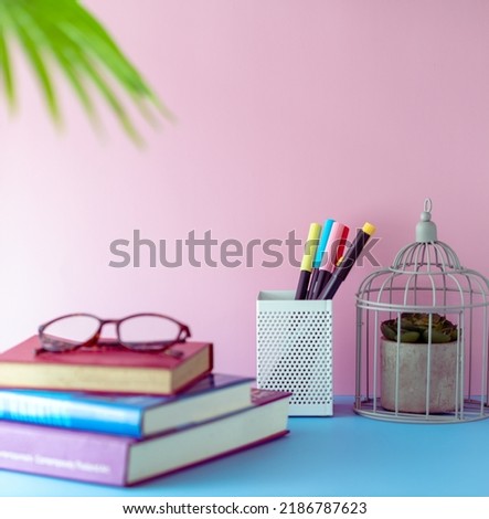 Back to school concept, Working or learning space design for student with blue tabletop and pink wall. Girly and feminine decoration style.