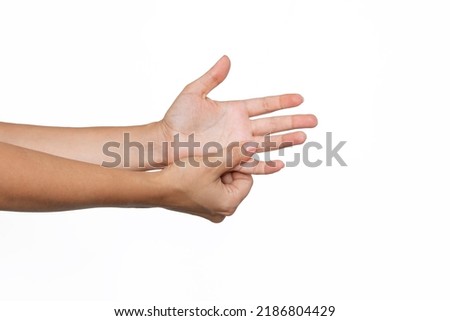Cropped shot of a young woman holding palm's fingers in her hand isolated on a white background. Numbness of the limbs. Injuries, arm pain, carpal tunnel syndrome, neuralgia. Medical concept