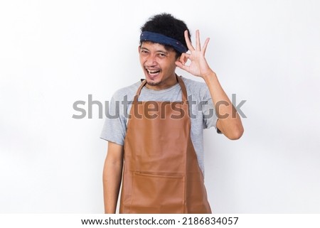 funny apron man smiling happy with ok sign gesture tumb up isolated on white background
