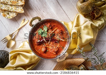 Indian spices Jodhpuri Laal Gosht or beef karahi with roti and kulcha served in a dish isolated on dark background top view of fastfood Royalty-Free Stock Photo #2186836415